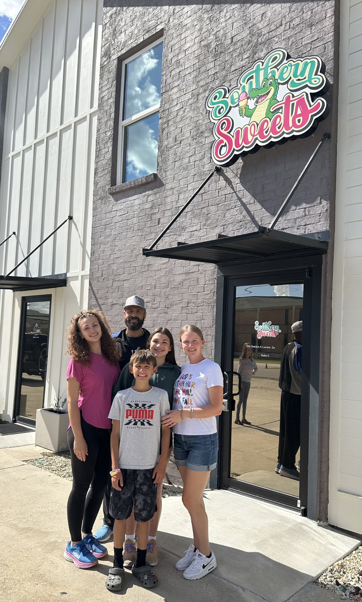 Jamie Fitch and family in front of the Southern Sweets shop